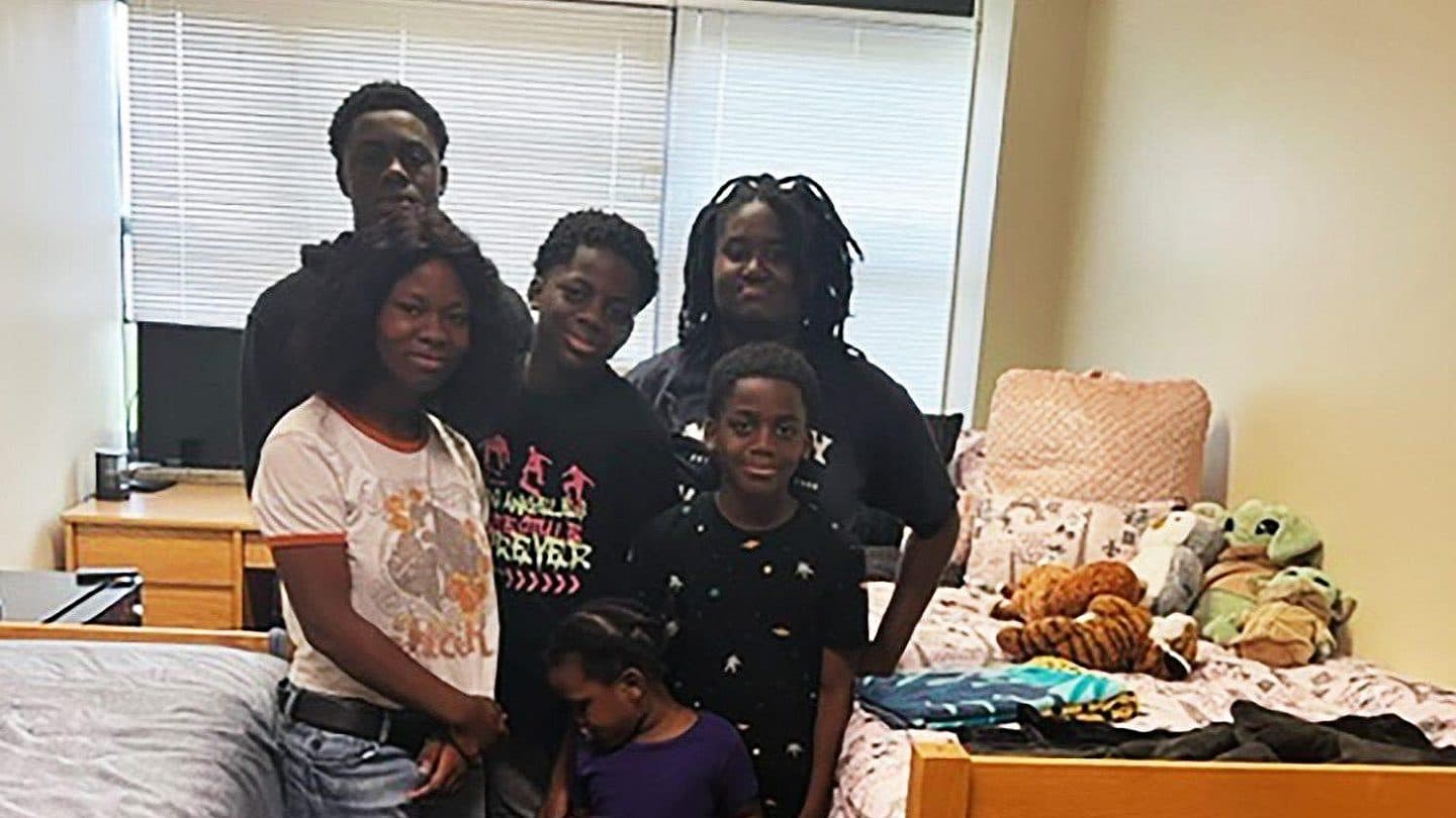 Aneeca stands with her family in her dorm.