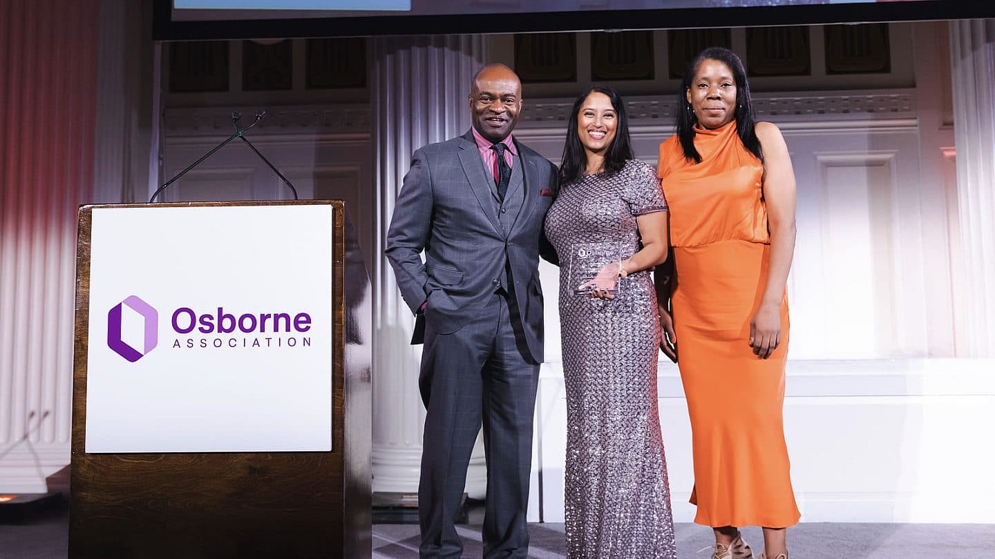 DeMaurice Smith stands on stage with Archana Jayaram and Ta'Chelle Carter