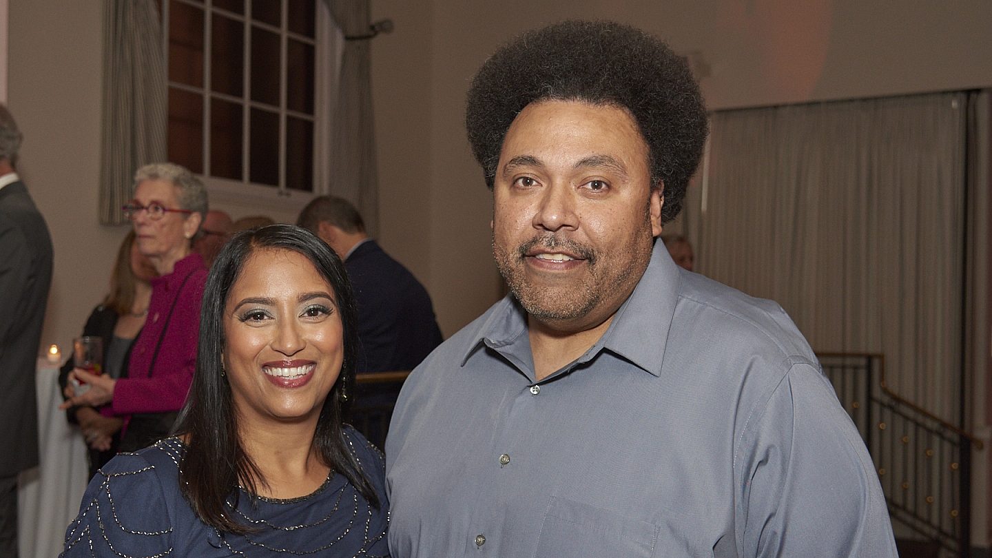Archana and Wilfredo standing together and smiling at the camera.