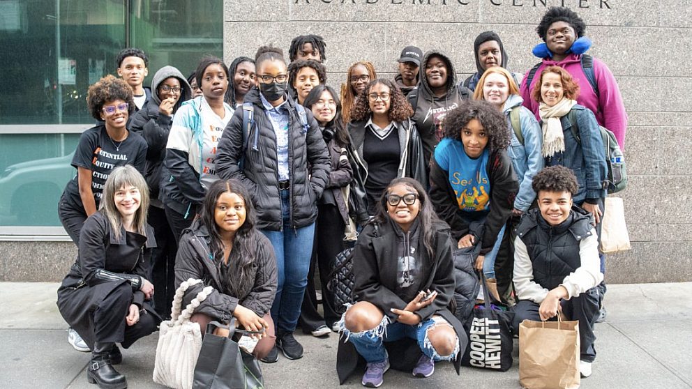 Youth Action Council members and Osborne staff stand in front of a building in Albany smiling at the camera.